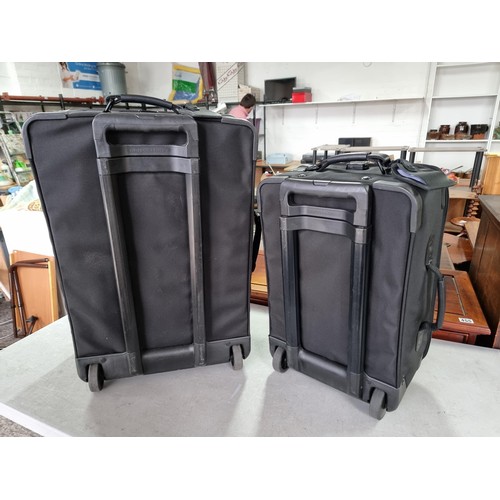 389 - Pair of very good quality Briggs & Riley suitcases in very good condition, along with a suit a suit ... 