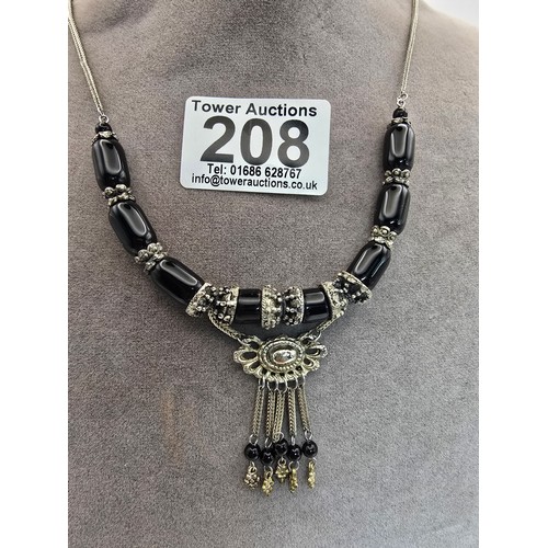 208 - A good quality vintage costume dress necklace featuring black glass beads, having an ornate drop wit... 