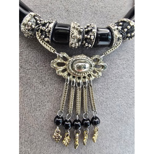 208 - A good quality vintage costume dress necklace featuring black glass beads, having an ornate drop wit... 