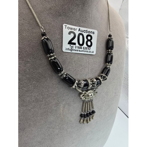 208 - A good quality vintage costume dress necklace featuring black glass beads, having an ornate drop wit... 