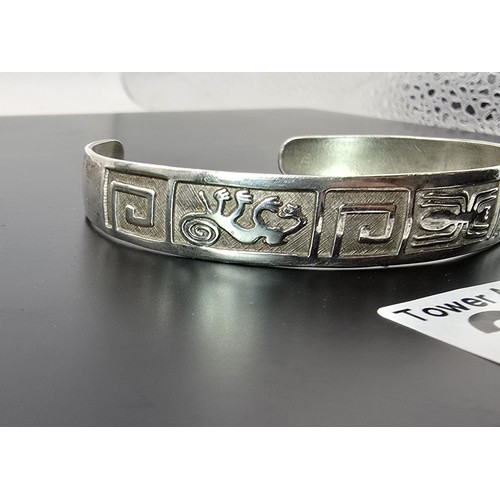 222 - A chunky 925 silver torque bangle having an Aztec South American design, is in good clean condition ... 