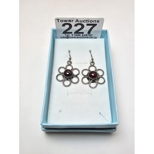 227 - A pair of pretty 925 silver drop earrings with a flower design inset with garnet cabochon stones, pr... 