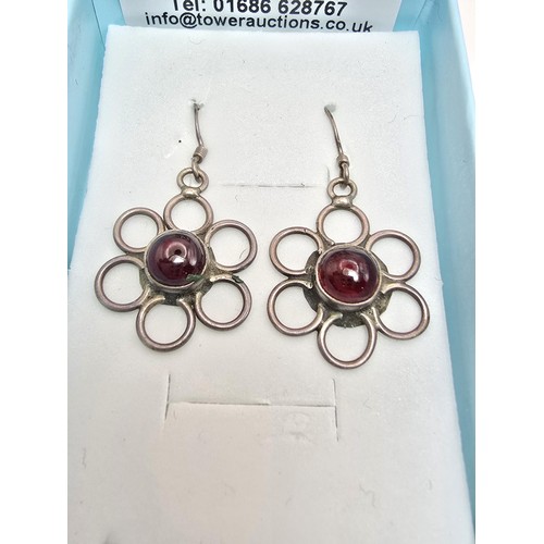 227 - A pair of pretty 925 silver drop earrings with a flower design inset with garnet cabochon stones, pr... 