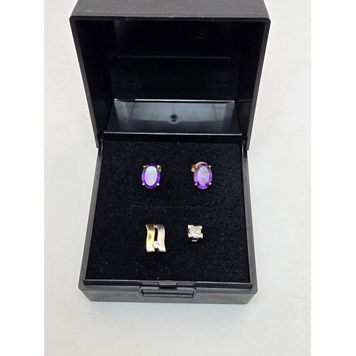 241A - A pair of pretty 9ct yellow gold stud earrings inset with vibrant purple amethyst gemstones along wi... 