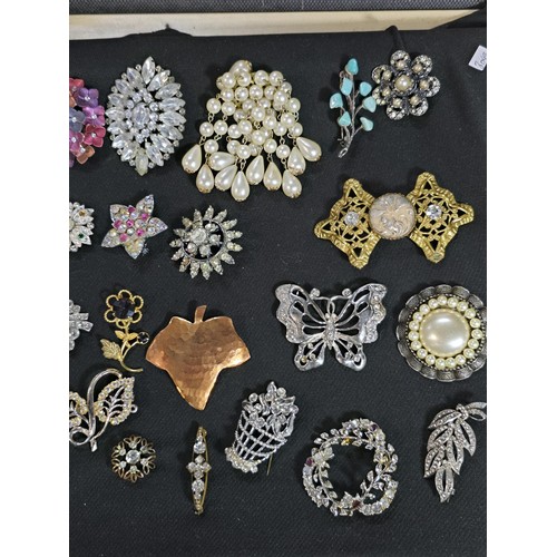 270 - A suite of approx 24 vintage ornate brooches on a display stand which is included featuring an ornat... 