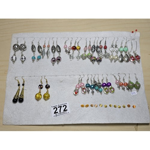 272 - A large bundle of approx 26 pairs of costume earrings all with interesting designs, some have art gl... 