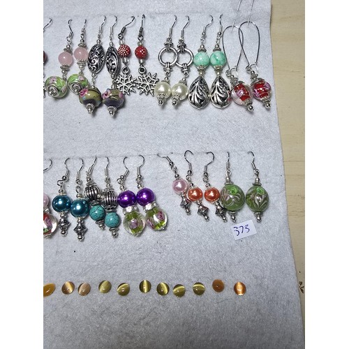 272 - A large bundle of approx 26 pairs of costume earrings all with interesting designs, some have art gl... 