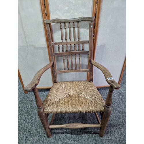 391 - Good quality antique Lancashire spindle back elm chair in good order with rush seat, showing good pa... 