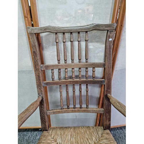 391 - Good quality antique Lancashire spindle back elm chair in good order with rush seat, showing good pa... 