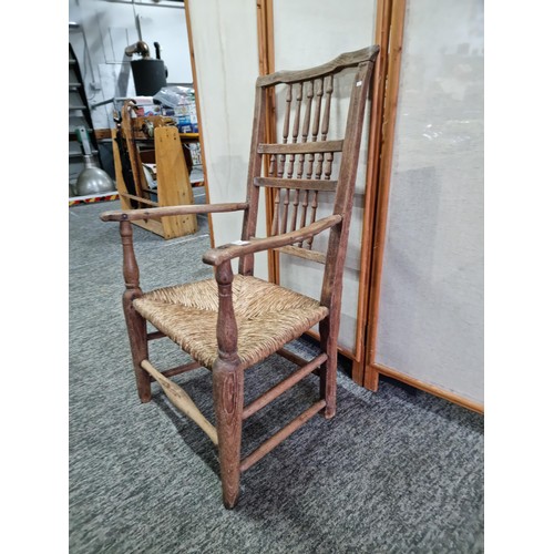 391 - Good quality antique Lancashire spindle back elm chair in good order with rush seat, showing good pa... 