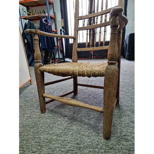 391 - Good quality antique Lancashire spindle back elm chair in good order with rush seat, showing good pa... 