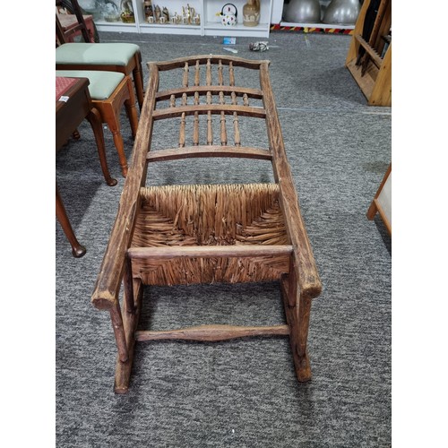 391 - Good quality antique Lancashire spindle back elm chair in good order with rush seat, showing good pa... 