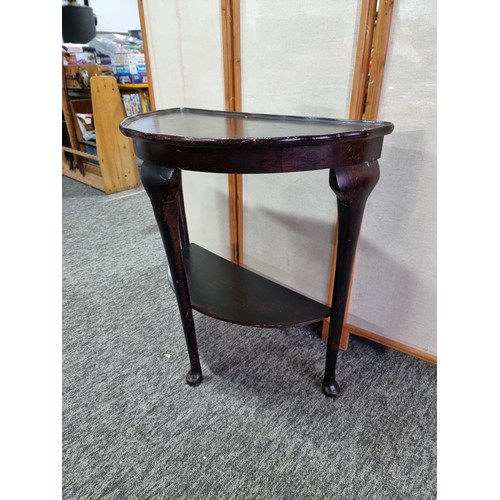 398 - Vintage demi lune hall table varnished in dark brown with shelf underneath in good overall condition... 