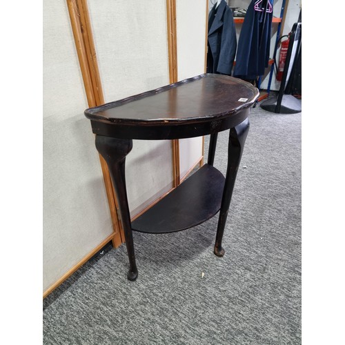 398 - Vintage demi lune hall table varnished in dark brown with shelf underneath in good overall condition... 