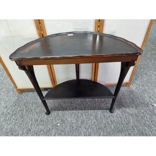 398 - Vintage demi lune hall table varnished in dark brown with shelf underneath in good overall condition... 