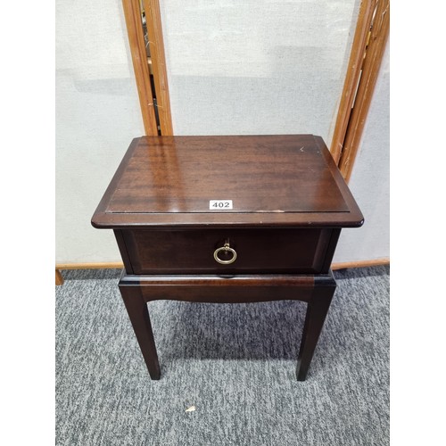 402 - Good quality Stag lamp table with single drawer to the top in good order with metal handle, stands a... 