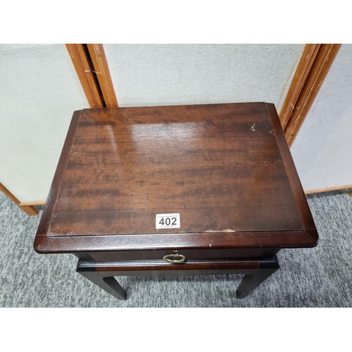 402 - Good quality Stag lamp table with single drawer to the top in good order with metal handle, stands a... 