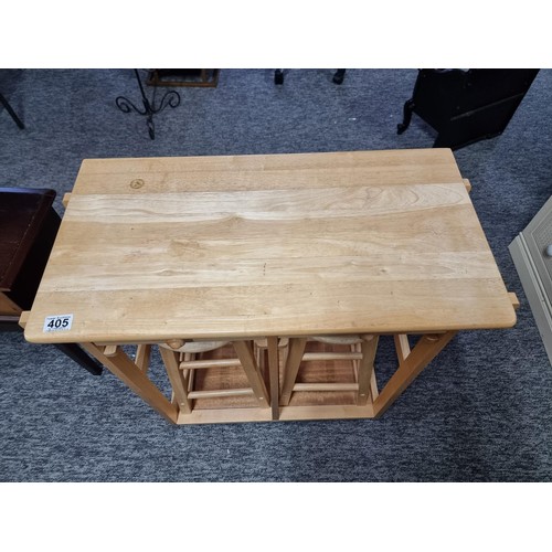 405 - Compact beech drop leaf table / breakfast bar in good order with two stools inside, table is on cast... 