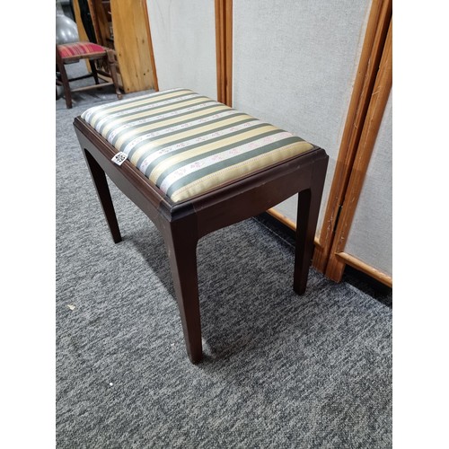 409 - Good quality mahogany piano stool with cushion top in striped floral design, in good order, has a he... 