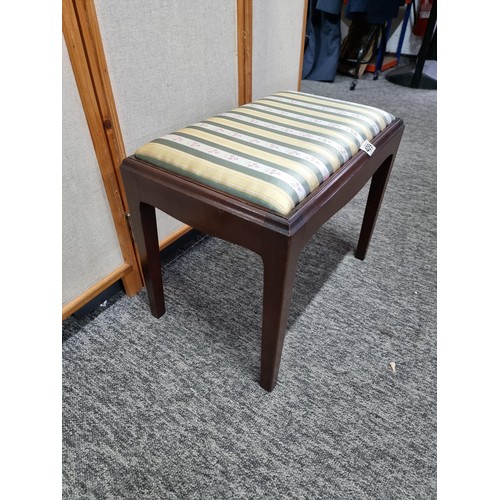 409 - Good quality mahogany piano stool with cushion top in striped floral design, in good order, has a he... 