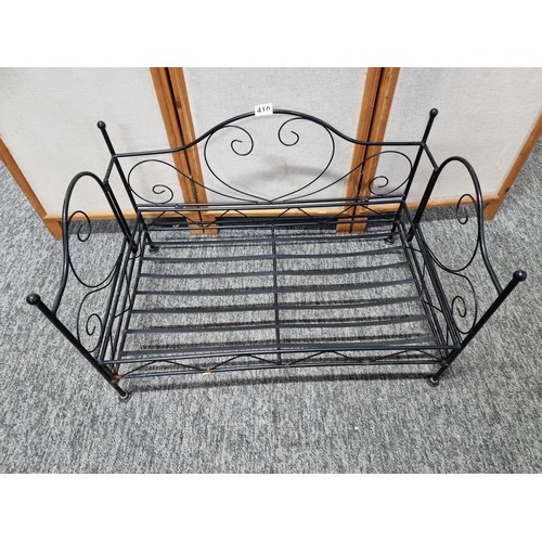 410 - Metal fold up dogs bed made of wrought iron in good order folds flat for ease of storage has a heigh... 