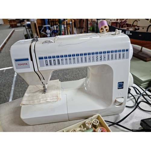 4 - A Toyota model RS2000 sewing machine having many stitch patterns and complete with its pedal along w... 