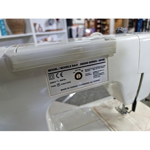 4 - A Toyota model RS2000 sewing machine having many stitch patterns and complete with its pedal along w... 