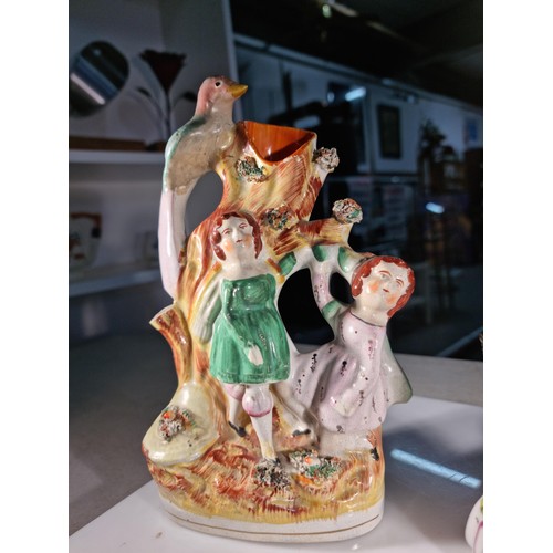 17 - Antique Staffordshire flat back vase depicting children and a bird on a tree with nibbles to the top... 