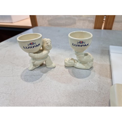 41 - Collection of 1980s Lurpak tableware to include 2x egg cups, 2x toast racks, and a butter dish. All ... 