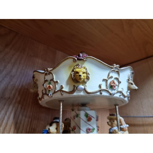 49 - Large Regency Fine Arts resin musical clockwork carousel depicting three teddy bears riding three an... 