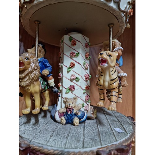 49 - Large Regency Fine Arts resin musical clockwork carousel depicting three teddy bears riding three an... 