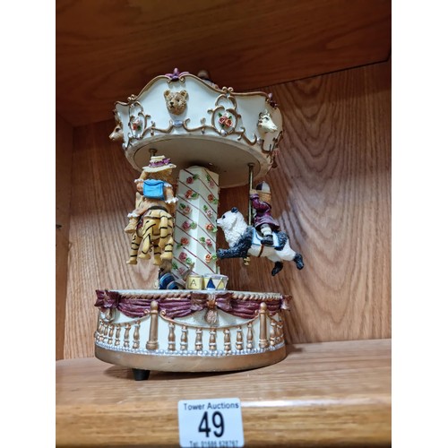 49 - Large Regency Fine Arts resin musical clockwork carousel depicting three teddy bears riding three an... 