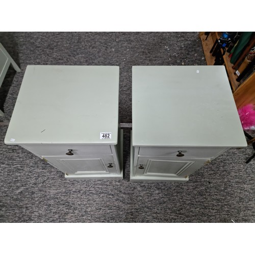 482 - Pair of clean and tidy light green painted bedside cabinets having door below one drawer with brass ... 