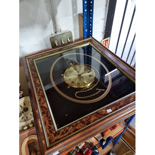 112 - Shelf containing a quantity of assorted clocks to include a framed and glazed quartz clock in the de... 