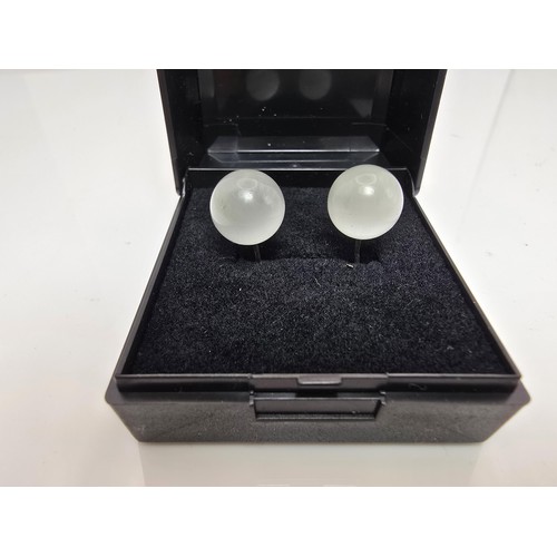 191A - A pair of unusual 925 silver stud earrings set with cats eye/moonstone type balls which have a  love... 
