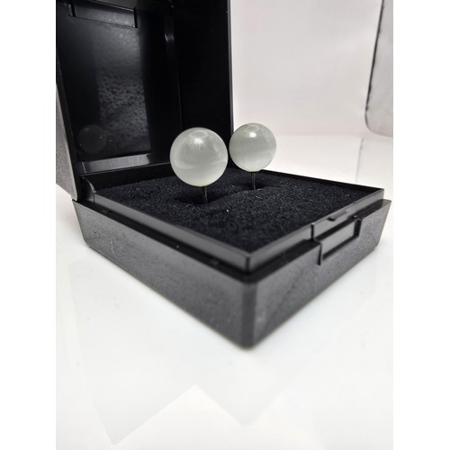 191A - A pair of unusual 925 silver stud earrings set with cats eye/moonstone type balls which have a  love... 