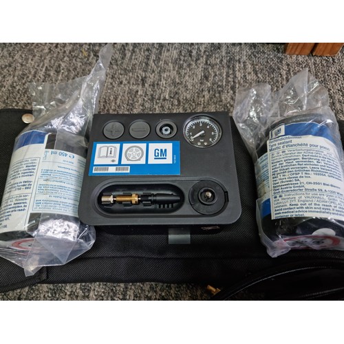 444 - Good GM portable 12v air compressor for inflating car tires complete set. 2 additional canisters of ... 
