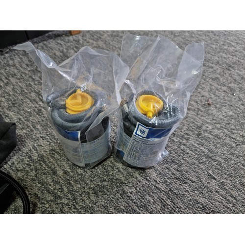 444 - Good GM portable 12v air compressor for inflating car tires complete set. 2 additional canisters of ... 