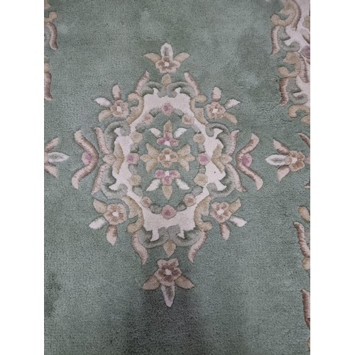 458 - A good quality Empora fire rug, 100% wool in green and cream. approx size 5ft x 3ft,