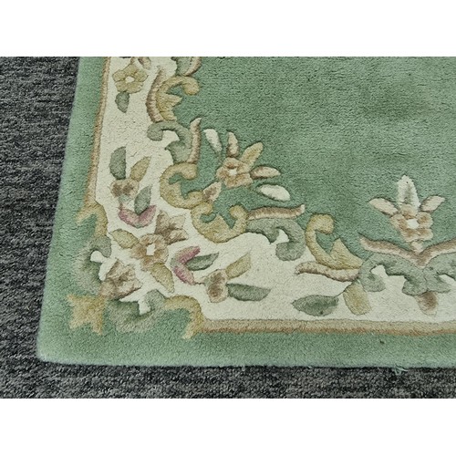 458 - A good quality Empora fire rug, 100% wool in green and cream. approx size 5ft x 3ft,