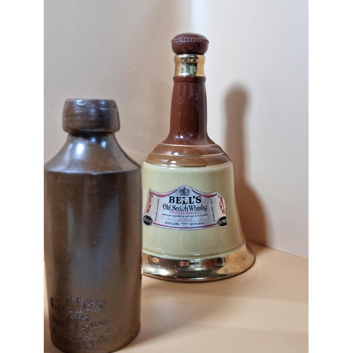 296 - A collection of 4x stone ware beer bottles all are named to include Slack & Cox of Manchester, G. Le... 