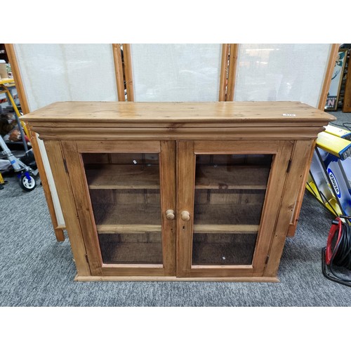 470 - Good quality solid pine vintage two door glazed book case which opens to reveal 3 shelves inside the... 