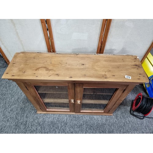470 - Good quality solid pine vintage two door glazed book case which opens to reveal 3 shelves inside the... 