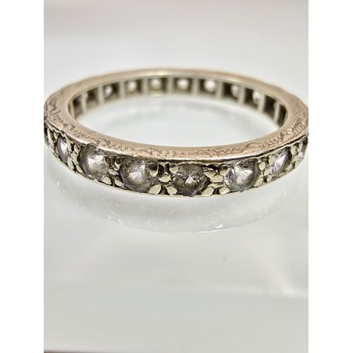 An attractive 9ct white gold eternity ring, has clear spinel gemstones ...