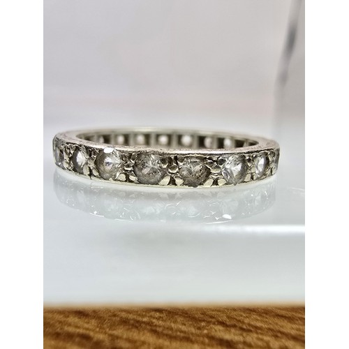 An attractive 9ct white gold eternity ring, has clear spinel gemstones ...