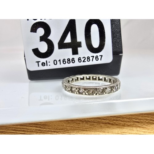An attractive 9ct white gold eternity ring, has clear spinel gemstones ...