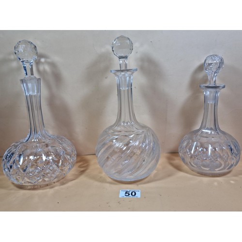 50 - Three good quality cut glass decanters complete with their original glass stoppers. All are in excel... 