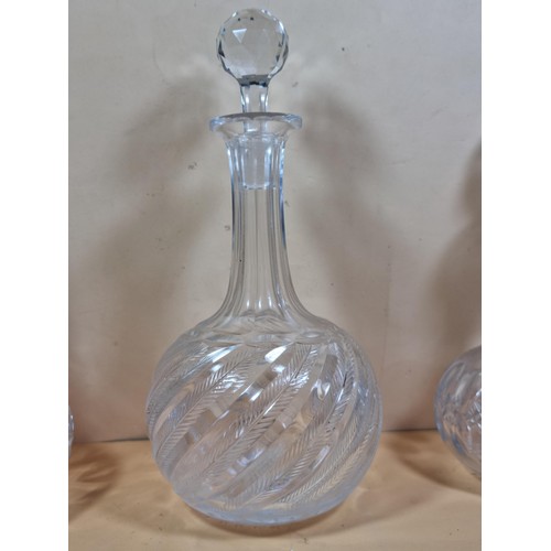 50 - Three good quality cut glass decanters complete with their original glass stoppers. All are in excel... 