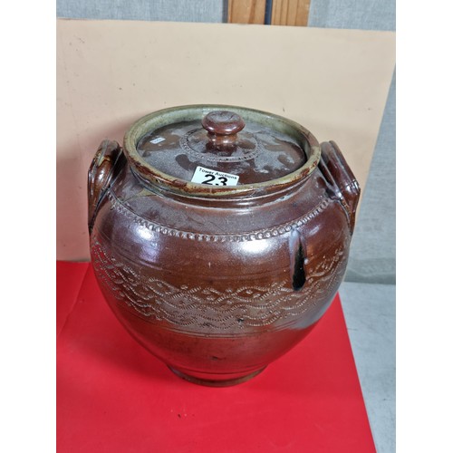 23 - A lidded stoneware brown coloured urn with lid with chips to the top along with a washing clothes do... 