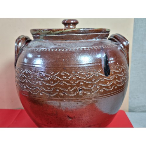 23 - A lidded stoneware brown coloured urn with lid with chips to the top along with a washing clothes do... 